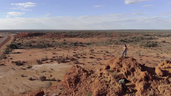 Aerial Shot of Young Woman Traveler Exploring Australian Remote Desert alt