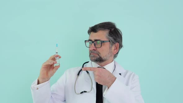Doctor Holds a Syringe and Vaccine Bottle at the Hospital on Blue Background alt