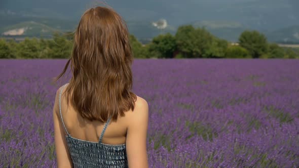 Portrait of young woman standing in lavender field in southern France