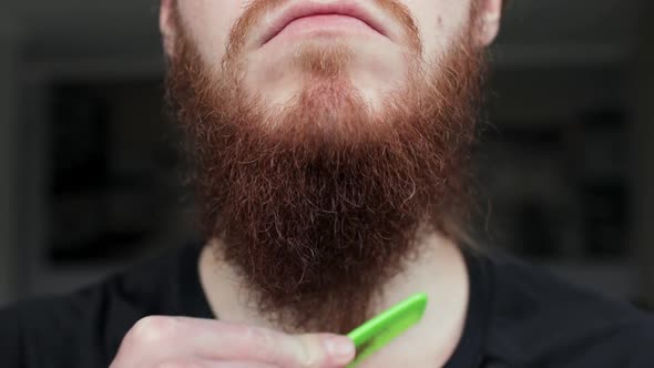 Close Up of Combing Hair Beard on Face Hipster