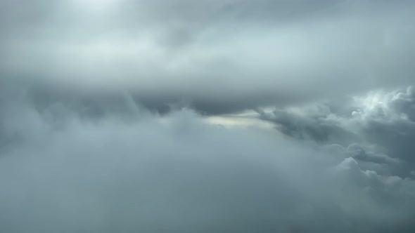 Awesome aerial pilot point of view flying through a turbulent and stormy  sky looking for a gap thro alt