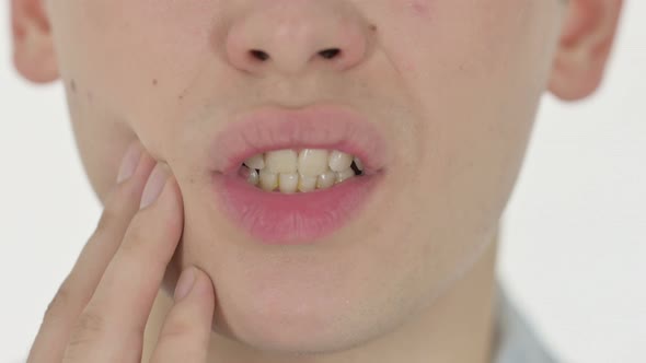 Close Up of Mouth With Toothache on White Background alt