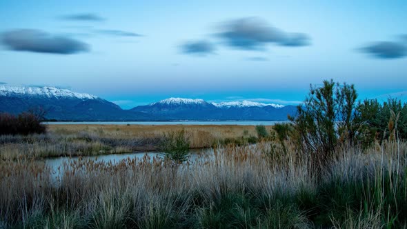 Cinemagraph of a cloudscapeing over a lake and mountain scene but the landscape is static alt