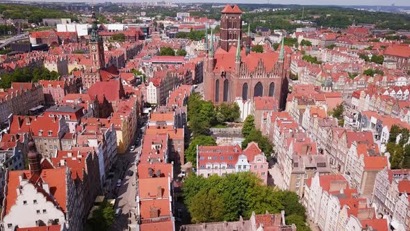 Gdansk Old Town Aerial. Cinematic rise shot of Bazylika Mariacka and the surrounding buildings