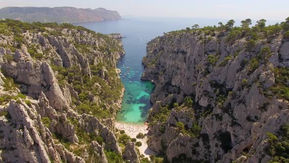 Aerial travel drone view of clear green water, cliffs of Cassis, Mediterranean Sea, Southern France. alt