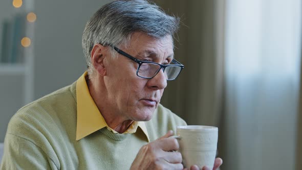 Caucasian Lonely Sad Sick Old Senior Man 60s Male 70s Grandfather Drinking Hot Tea Liquid alt