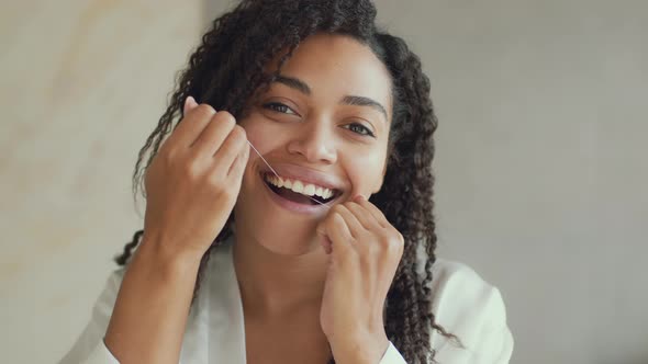 Mirror Pov Portrait of Young Happy African American Woman Flossing Her Teeth with Toothfloos at alt