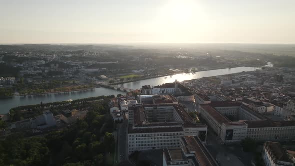 Coimbra University and Mondego river with landscape in background, Portugal. Aerial forward alt