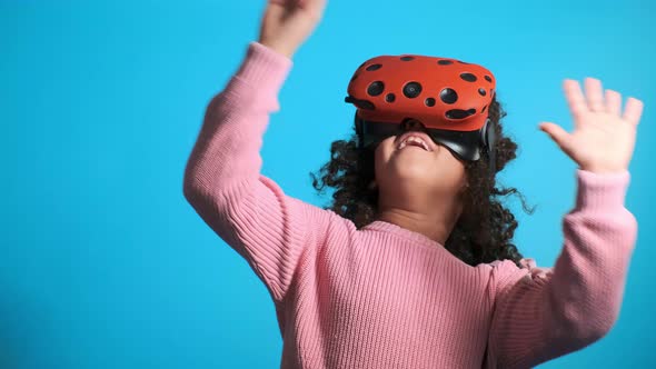 African American Girl Touches Virtual Thing Enjoying VR