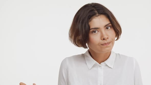 Young Beautiful Brunette East Asian Female in Shirt Disapproving on White Background in Slowmotion alt