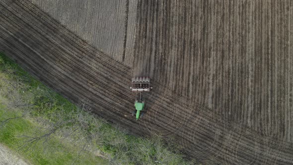 Top down view of arm being tilled for planting. Straight rows with semi circle swirls at the ends.