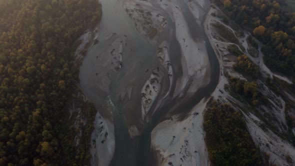 Aerial view Laba river flood, forest at dawn, autumn, natural water earth patterns, Caucasus Russia