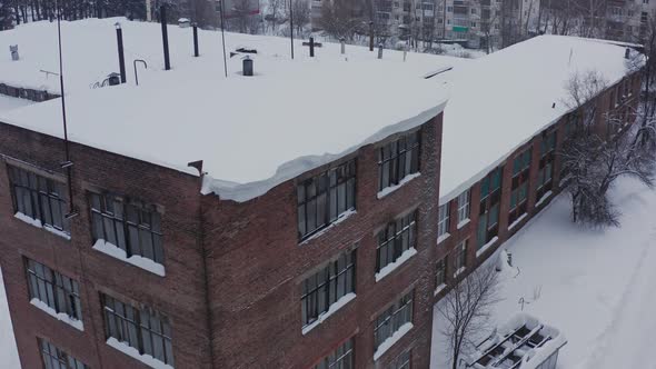 Brick Facade of the Industrial Building Against the Background of the Winter Landscape