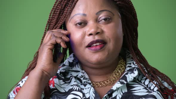 Overweight Beautiful African Woman Against Green Background alt