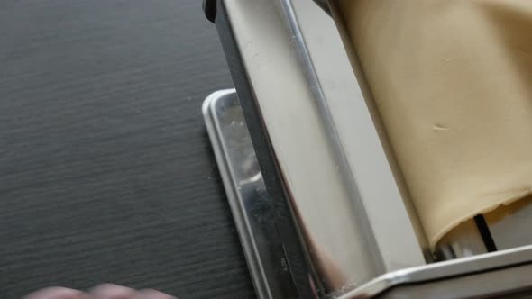 Kitchen pasta machine on the table 4K 2160p 30fps UltraHD footage - Manually processed  dough for It alt