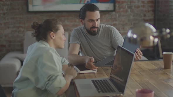 Friends are Working Together on a Common Project Smiling and Laughing alt