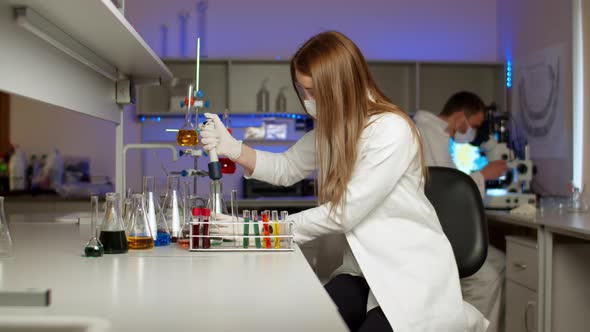 Young Scientist Mixing Colored Liquids