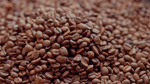 Full Frame Looped Spinning Background of Pile of Roasted Coffee Beans