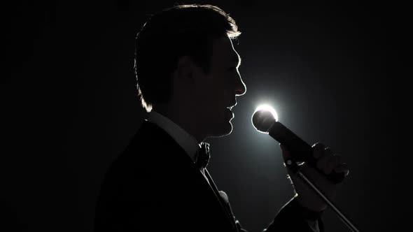 Politician Man in Suit Is Speaking Microphone Standing on Stage in Spotlight