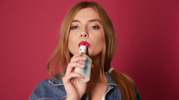 Beautiful bad blond girl. Model exhaling smoke from electronic cigarette vaporizer