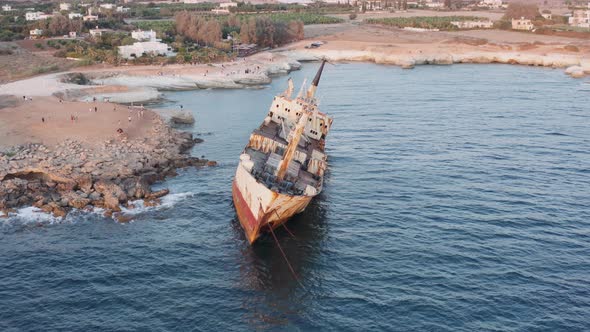 Aerial Of Rusty Shipwreck Close To Shore With Crashing Waves During Sunset 5