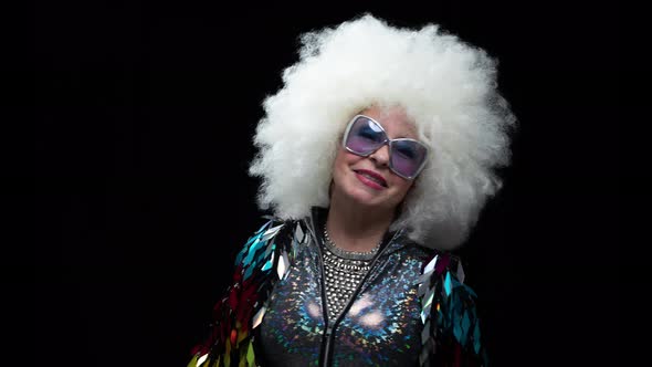 Senior Woman Dancing in Disco with Headphones alt