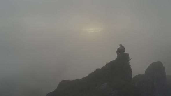 Man In The Fog On A Rock