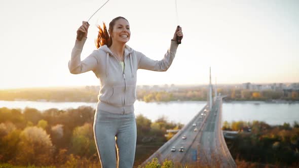 Sportswoman Using Jumping Rope to Stay Fit Outdoor