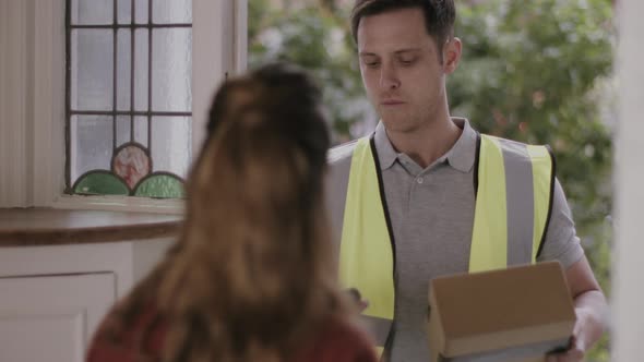 Delivery man delivering parcel at home