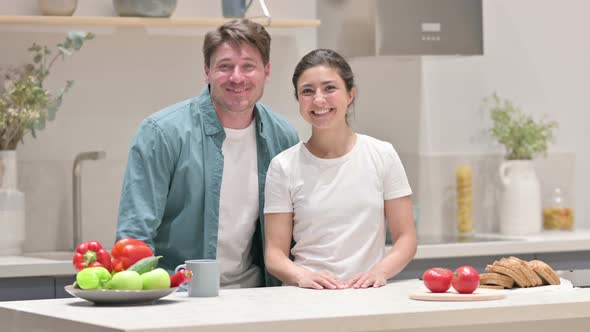 Mixed Race Couple Doing Video Call While Standing in Kitchen alt