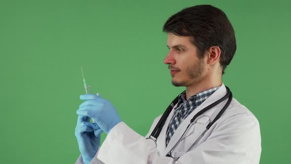 Handsome Male Doctor Preparing Syringe with Vaccine  alt