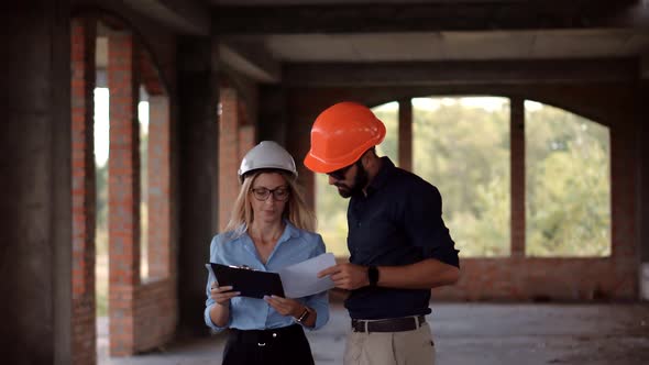 Developer On Construction Site. Civil Engineer Architect On Construction. Two Engineer Builder. alt