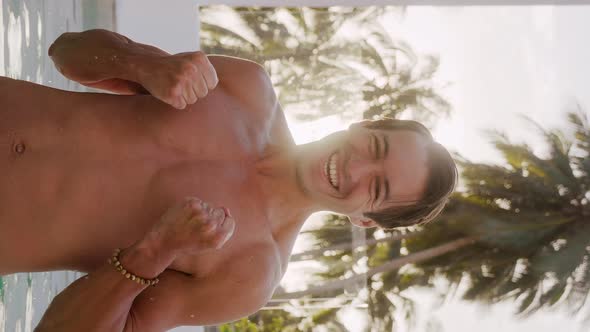 Vertical Video Portrait of Smiling Excited Young Man Looking at Camera and Rejoicing in a Win or alt