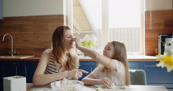 Mother and Daughter Baking Cooking Together in the Kitchen at Home alt
