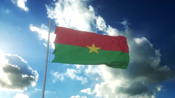 Flag of Burkina Faso Waving at Wind Against Beautiful Blue Sky alt