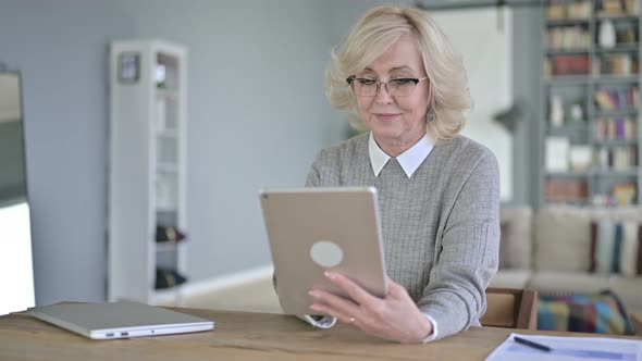 Old Woman Using Tablet in Modern Office alt
