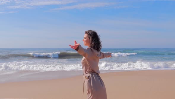 Happy Woman Having Fun with Arms Up on Beach in Summer During Holidays Travel alt