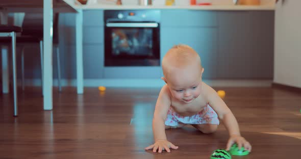 Small Child is Playing and Crawling on the Floor alt