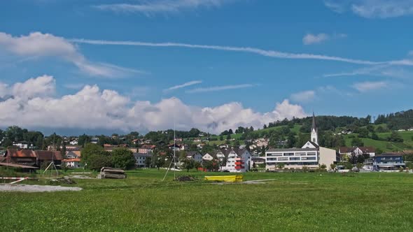 Panoramic View Liechtenstein with Houses on Green Fields in Alps Mountain Valley alt