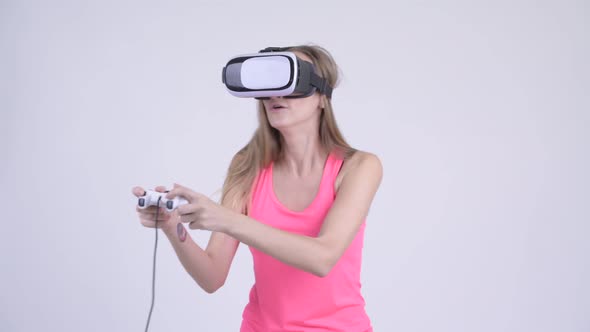 Blonde Woman Playing Games and Using Virtual Reality Headset alt