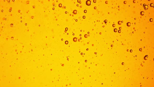 Super Slow Motion Shot of Moving Oil Bubbles on Golden Background at 1000Fps alt