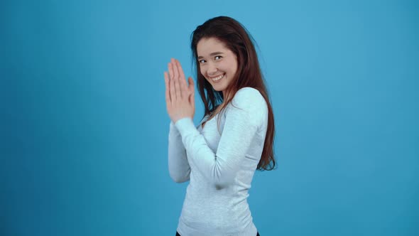 The Young Conspiratorial Brunette Rubs Her Hands and Looks in Parts Thinking of a Plan alt