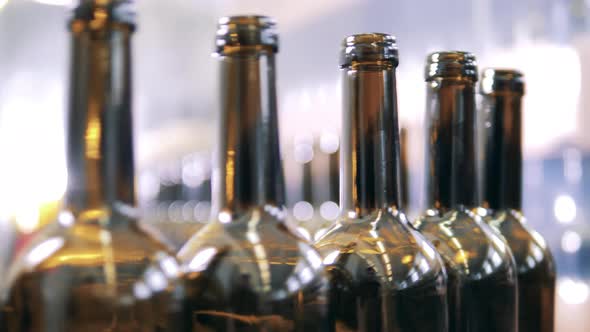 Close Up View of Wine Bottles Moving Slowly Along the Production Line alt