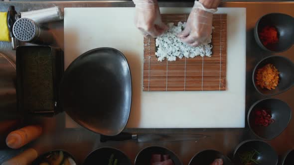 Top Down View of Professional Chef Making Sushi alt