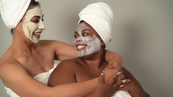 Happy multiracial women with different age and body size having skin care spa day alt
