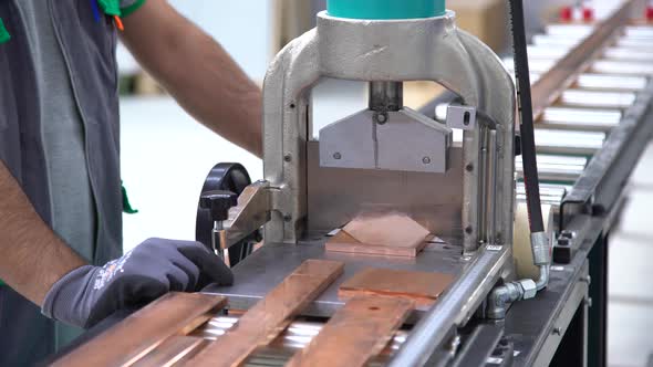 Worker Cuts Copper Plates With Guillotine
