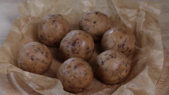 Useful Homemade Sweets.  Coconut Flour With Dark Chocolate.  In The Form Of Balls.  On Pine Boards alt