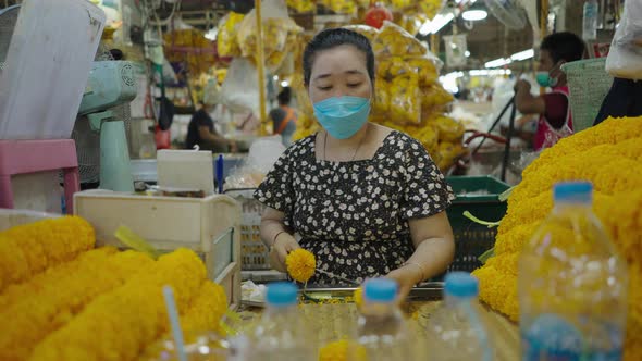 Seller Making Marigold Garlands Inside Pak Khlong Talat Market Amidst Covid19 Outbreak In Bangkok alt