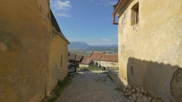 Alley with old stone houses at Rasnov Citadel alt