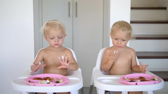 Twin Sisters Enjoying Their Vegan Dessert Licking the Cream of Their Little Fingers While Lunching alt